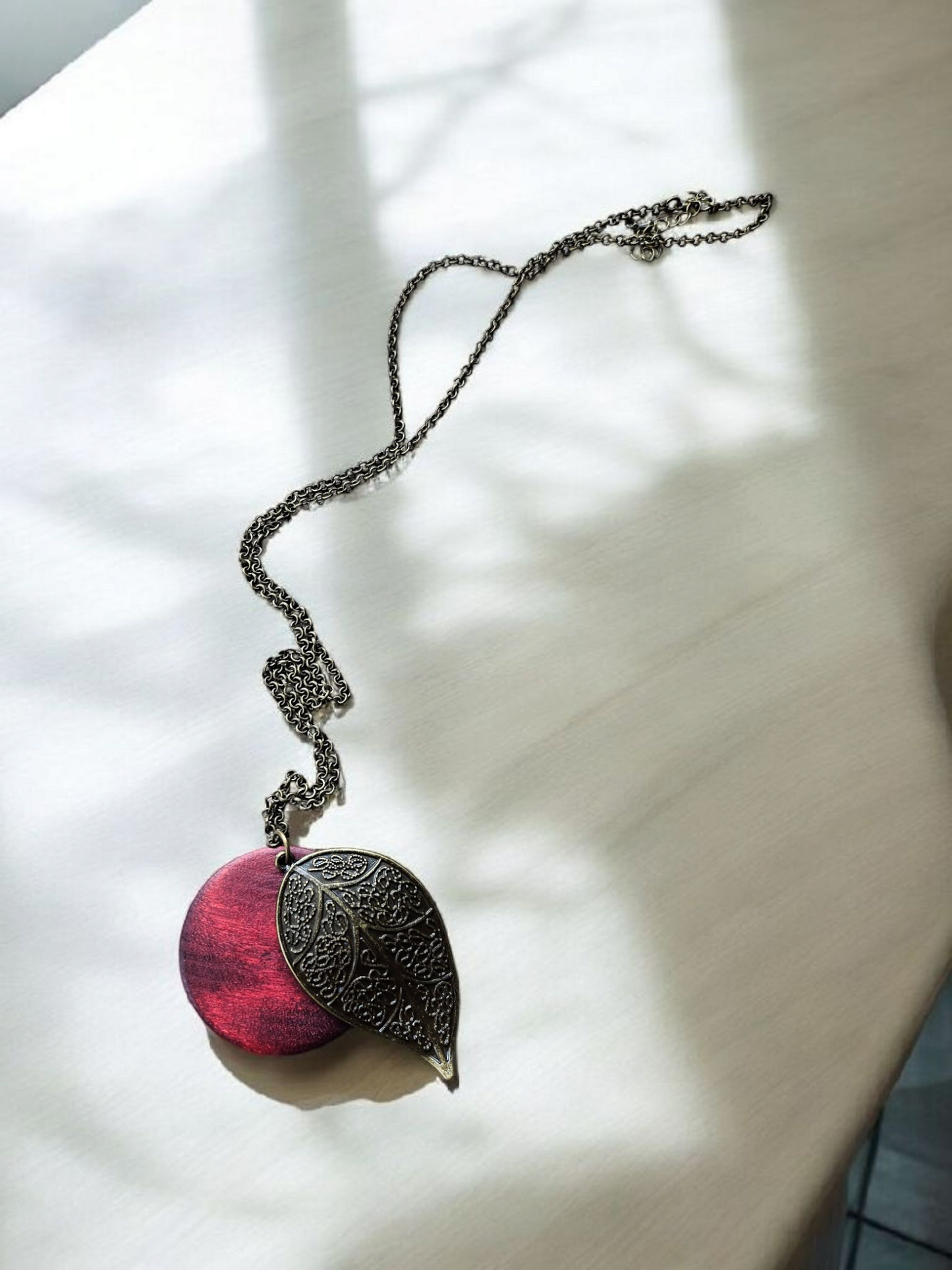 Bronze Leaf and Burgundy Wooden Circle on Long Bronze Necklace