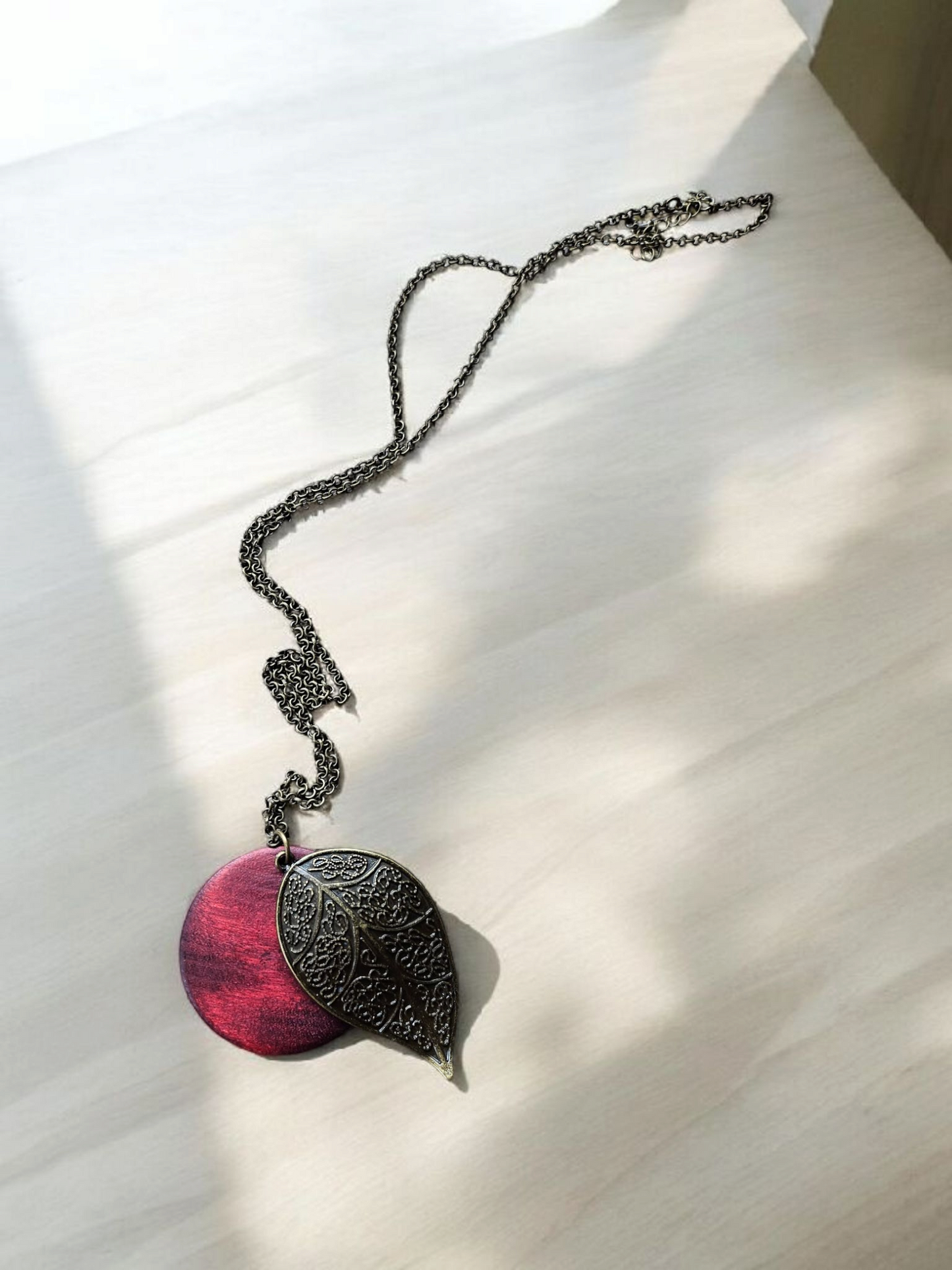 Bronze Leaf and Burgundy Wooden Circle on Long Bronze Necklace