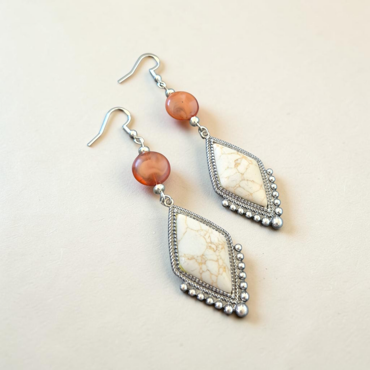 Fury Jewelry & Design bohemian drop earrings with white diamond-shaped stone, carnelian bead, and antiqued silver frame.